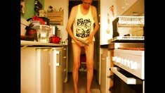 balancing my genitals nude in the kitchen