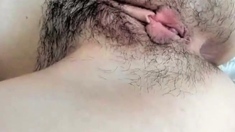 Hot Babe fingering her hairy pussy and enjoys it