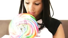 Busty babe get nude while sucking lollipop