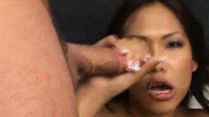 Naughty Asian chick uses her lips and hands to please two big pricks