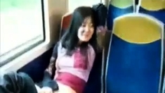 Asian milf rubs her clit on a train.